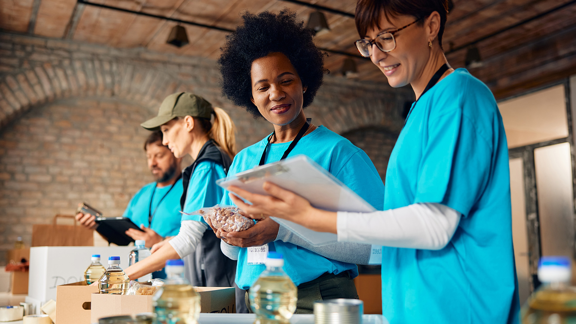 Image of volunteers and coworkers packing donations at food bank